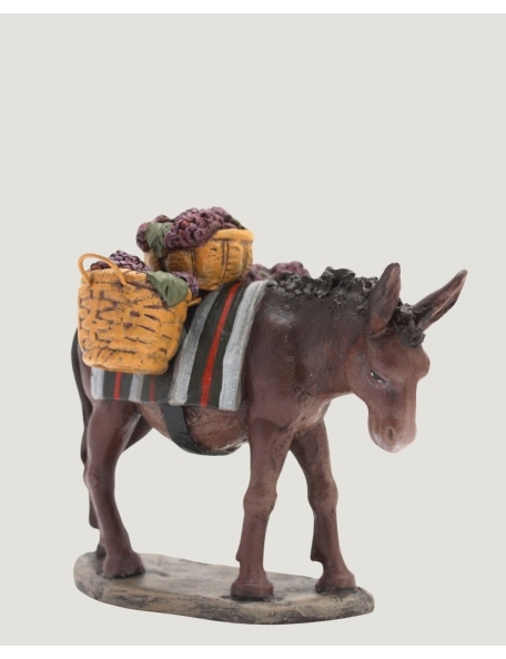 Figures of the Nativity scene, donkey with baskets of grapes